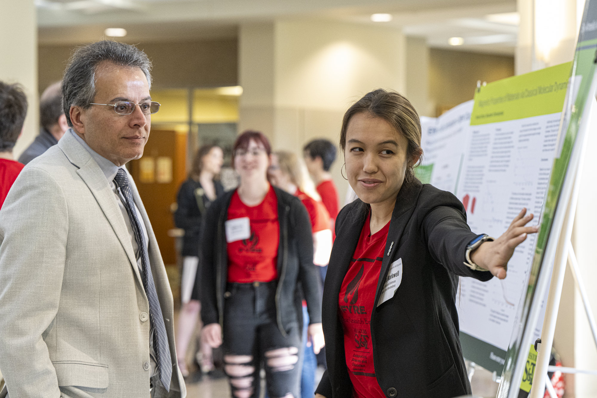 faculty and student at poster presentation